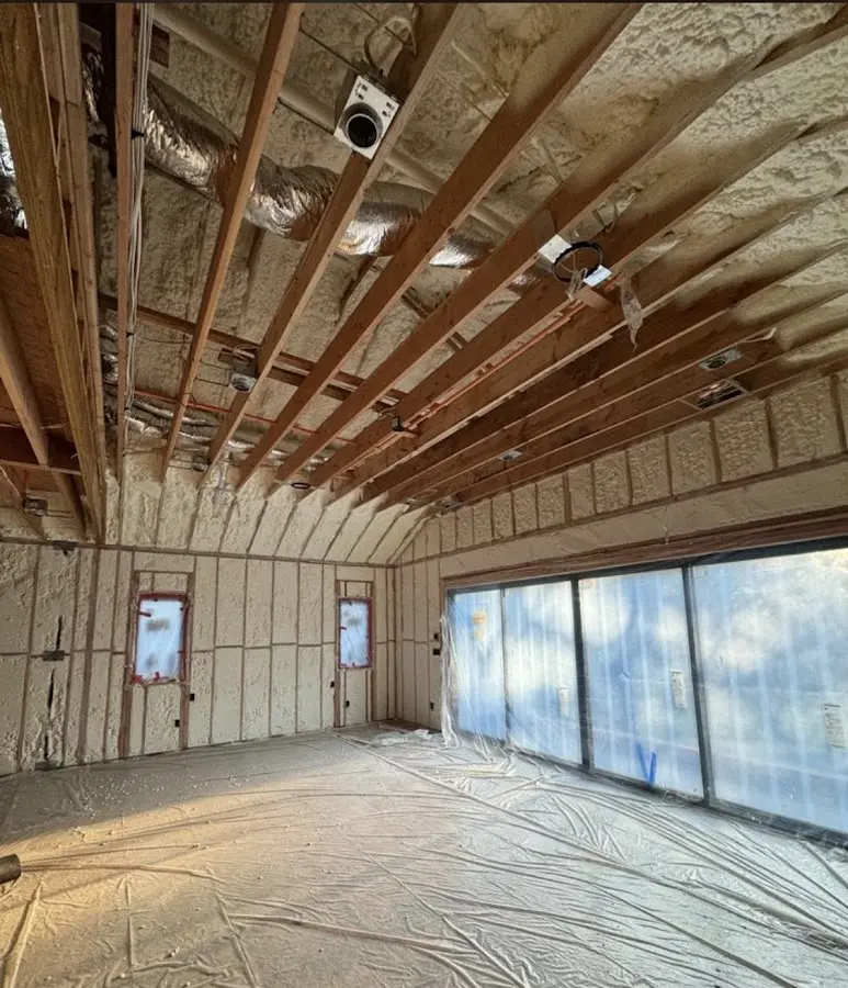 Interior walls and ceiling insulated with spray foam during new construction in Carrollton